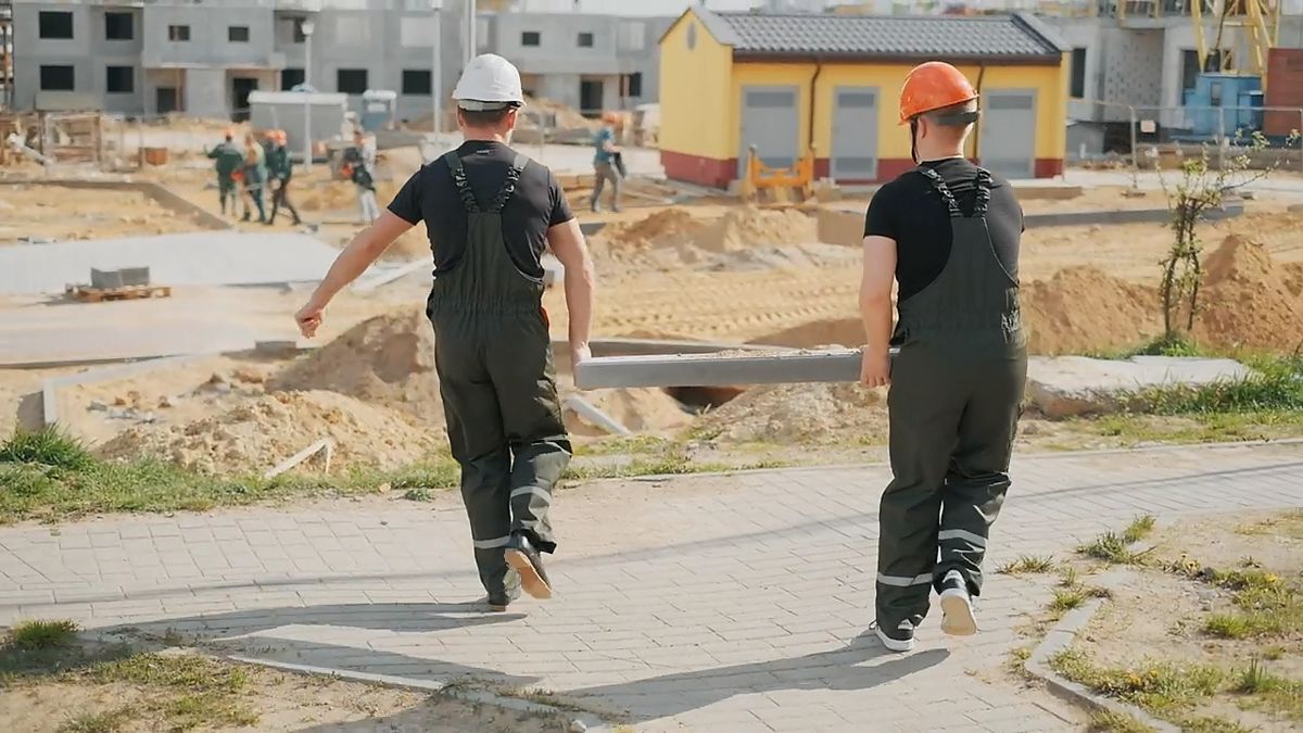 Deux travailleurs en route sur un chantier résidentiel
